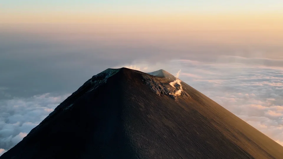 Crater of Acatenango volcano above the clouds at sunset, Guatemala