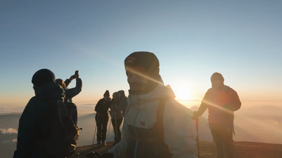 Hikers silhouetted against the sunrise at the summit of Acatenango, Guatemala