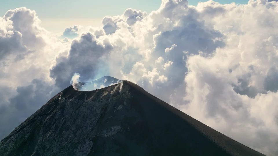 Volcán Fuego smoking through the clouds, seen from Acatenango, Guatemala