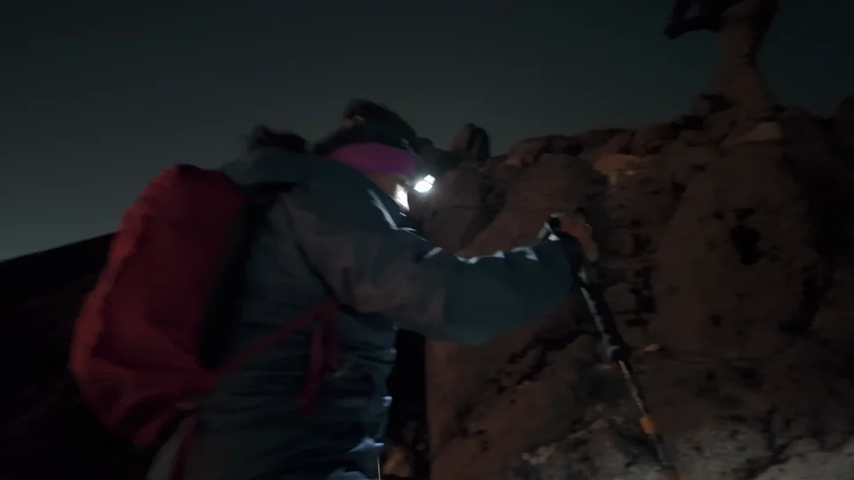 Hikers with headlamps climbing Acatenango in the dark before sunrise, Guatemala