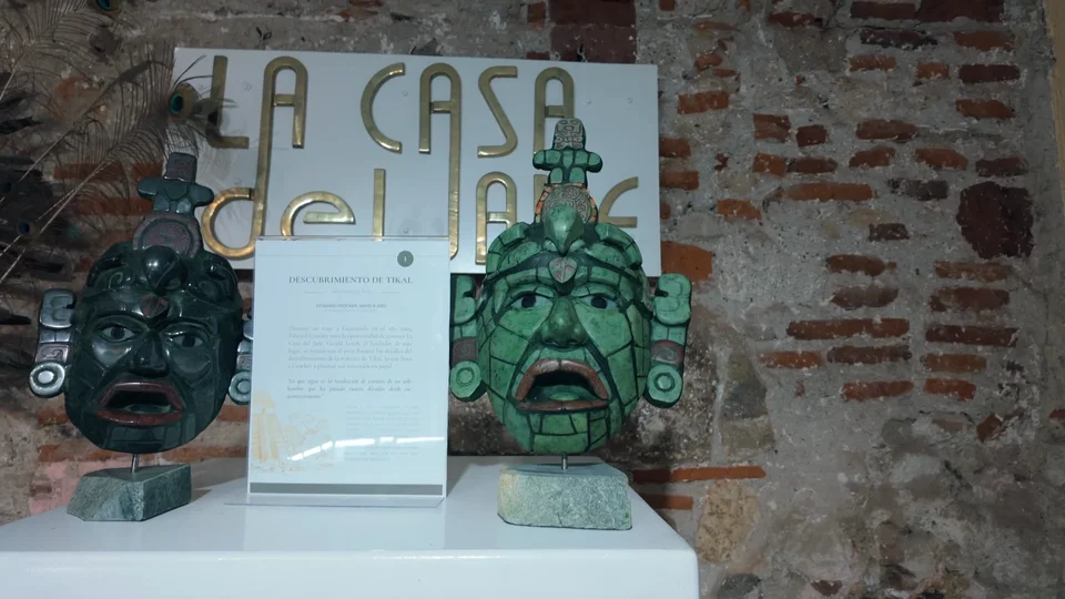 Carved green jade masks on display at La Casa del Jade, Antigua, Guatemala