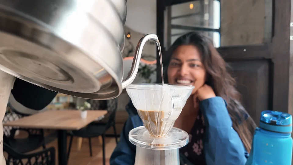 Barista pouring a V60 coffee at a cafe in La Candelaria, Bogotá