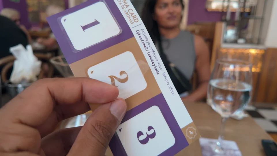Coffee flight tasting cards at Café San Alberto in Cartagena