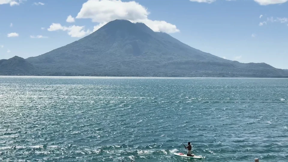 Paddleboarding on Lake Atitlán with volcano views near Free Cerveza hostel, Guatemala