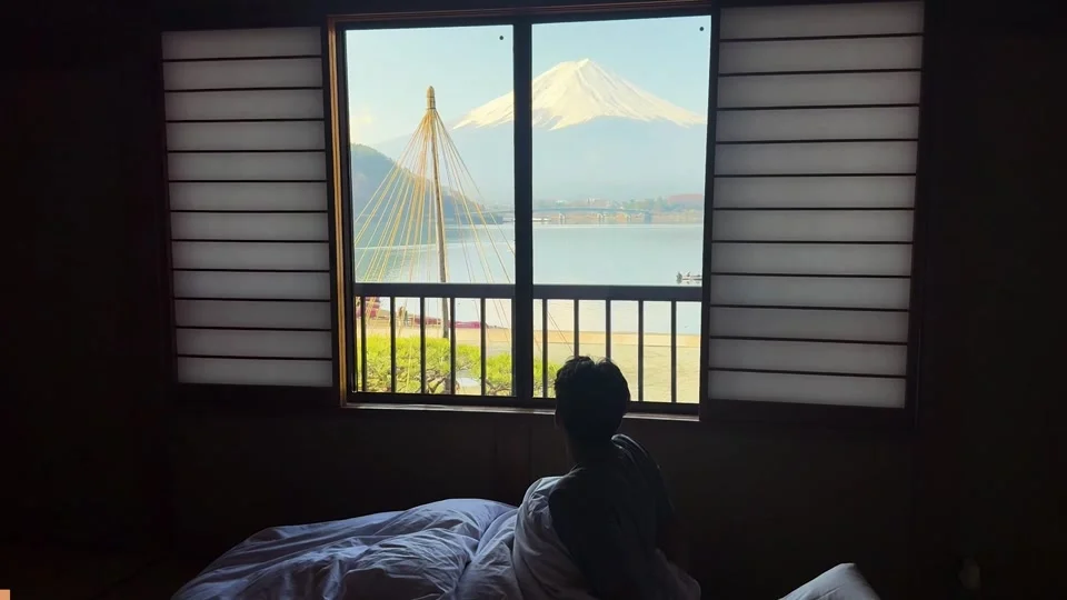 Mount Fuji seen from a ryokan window over the lake