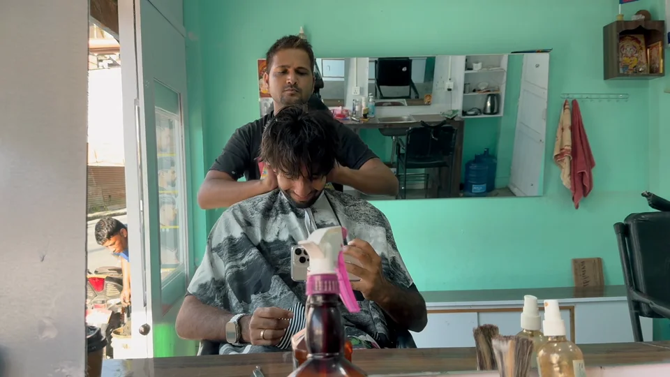 Getting a haircut from a street barber in Kathmandu, Nepal