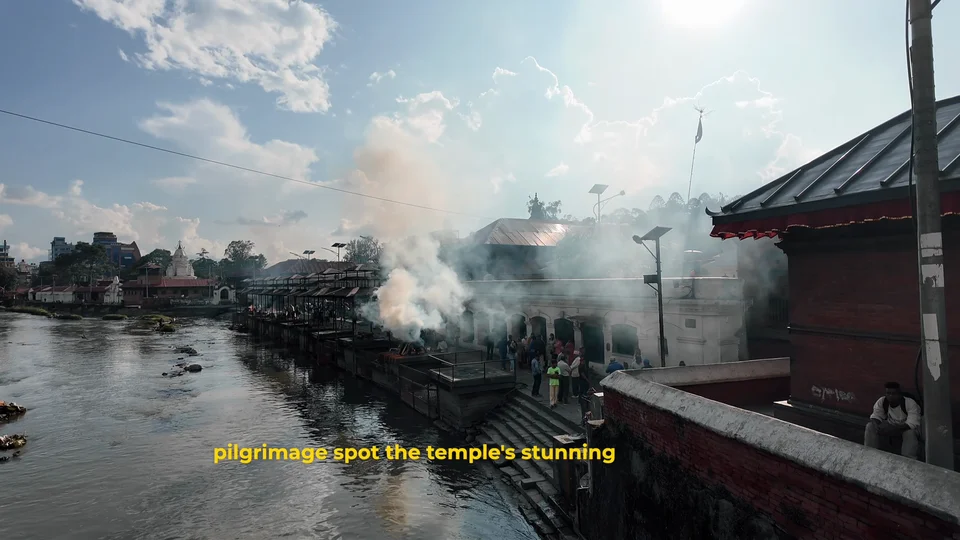 Cremation ceremony smoke rising along the river at Pashupatinath Temple, Kathmandu