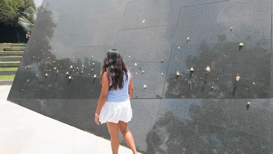 Memorial wall covered in bullet holes at Parque Inflexión, site of Pablo Escobar's former residence, Medellín