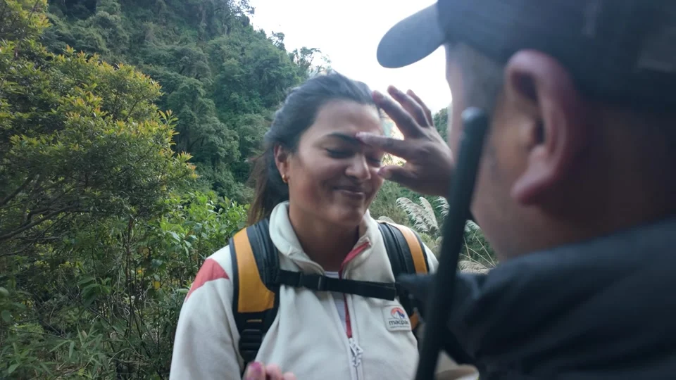 Applying natural berry face paint on the Salkantay Trek