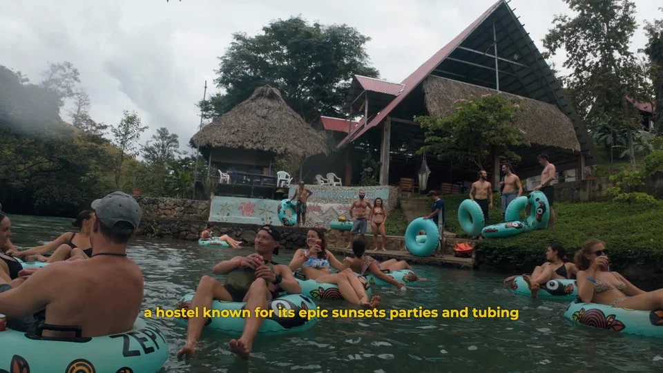 Zephyr Lodge on the Cahabón River near Lanquín, Guatemala, with tubers gathering by the water