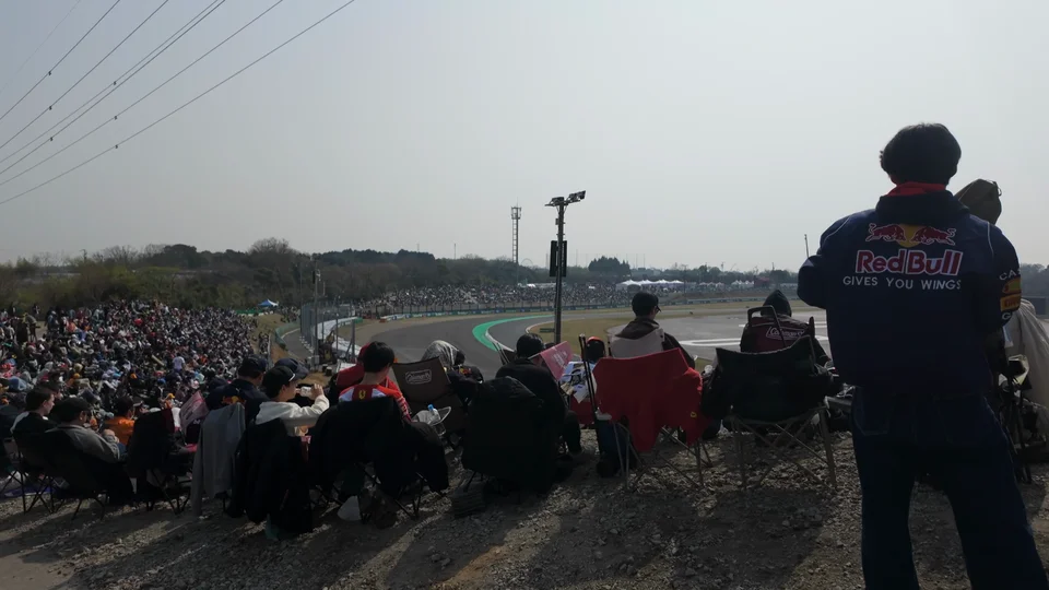 Fans on a grass bank overlooking the Suzuka Circuit hours before the race