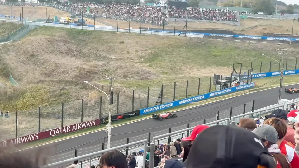 Formula 1 cars racing through Suzuka during the Japanese Grand Prix