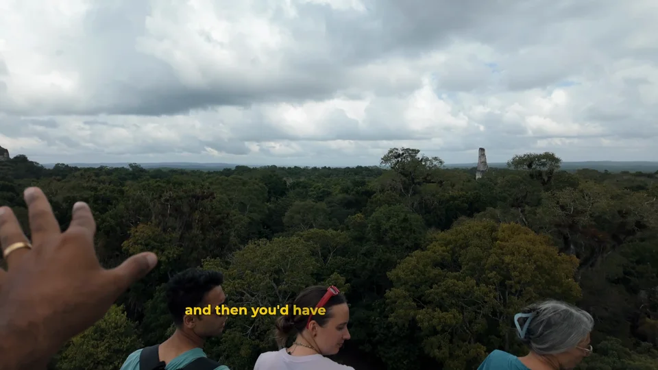View over the jungle canopy from Temple IV at Tikal, Guatemala, with a temple peeking through the trees