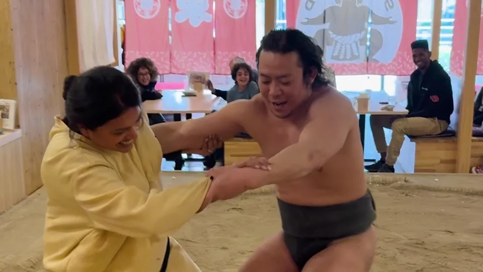 Trying to push a sumo wrestler at Sumo Land, Ryogoku