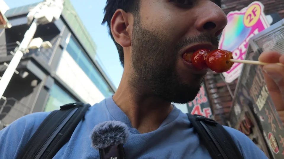 Eating a candied strawberry on a stick, Takeshita Street, Harajuku