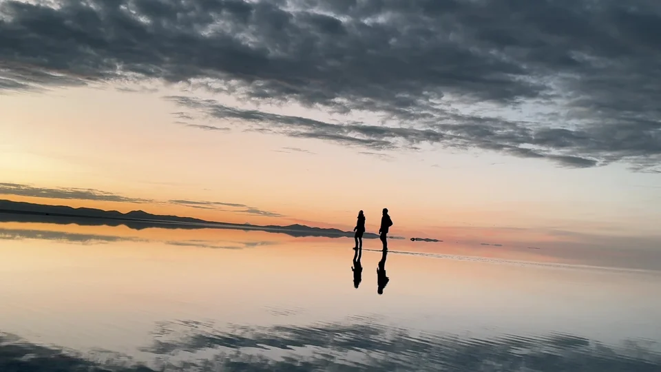 Sunrise reflected perfectly on the mirror-like Uyuni Salt Flats
