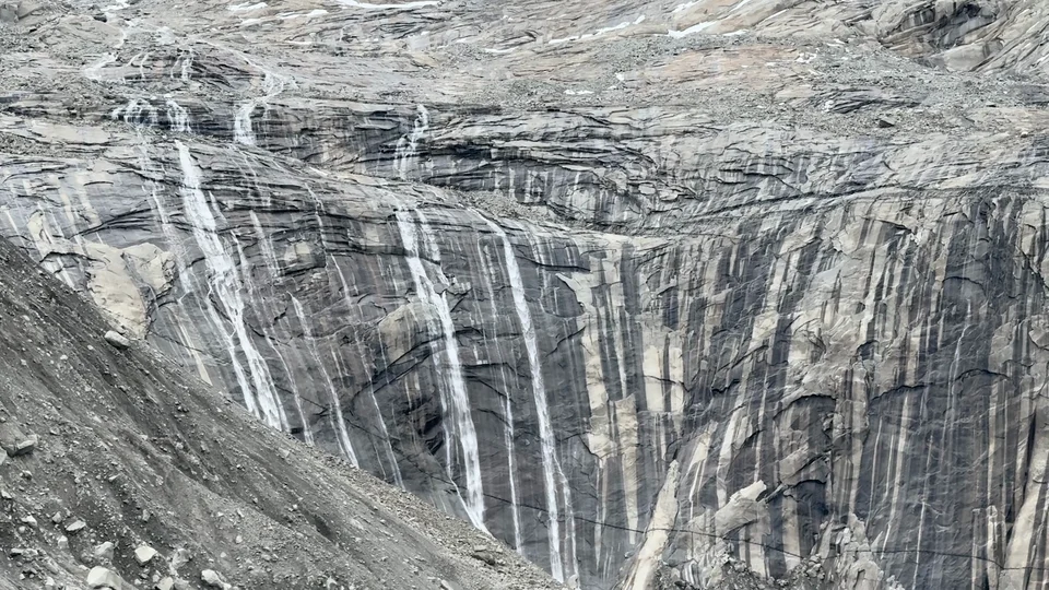 Waterfalls streaking down granite cliffs at the base of Torres del Paine