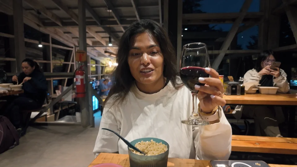 Raising a glass of wine to celebrate finishing the longest day of the W Trek