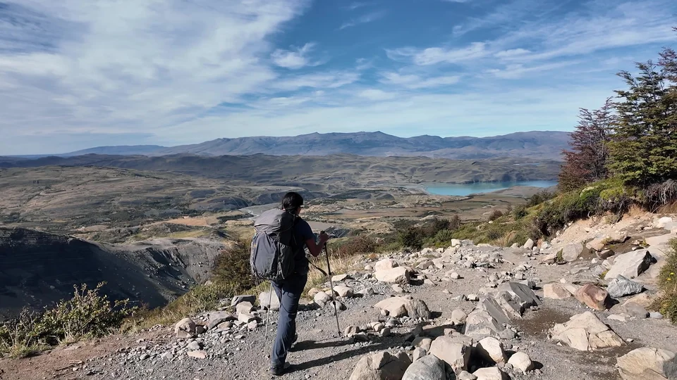 Hiker overlooking a lake on the W Trek trail, Torres del Paine
