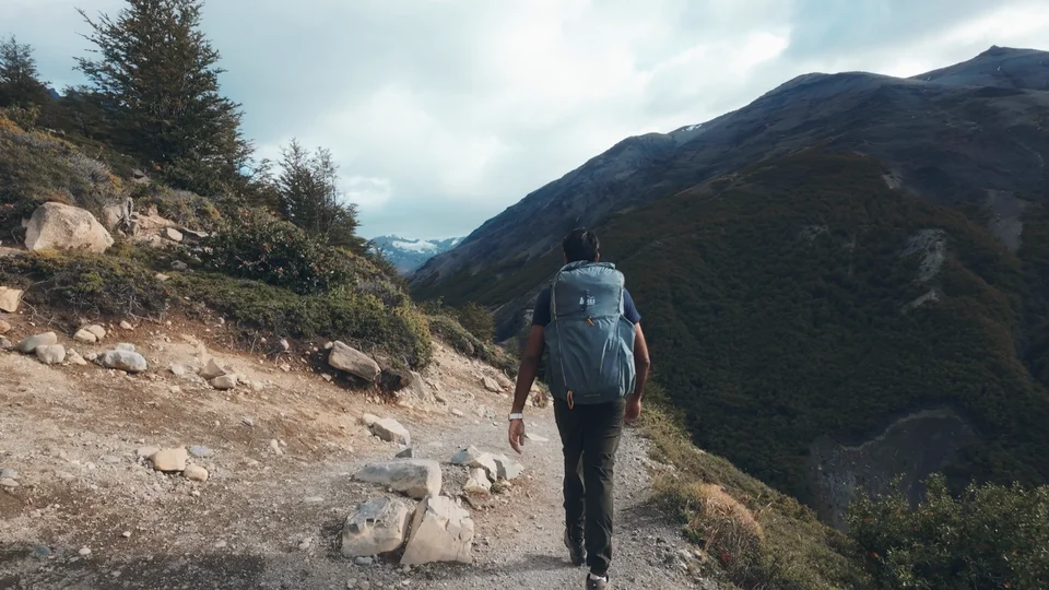 Hiker walking along a bare ridge trail on the W Trek, Patagonia